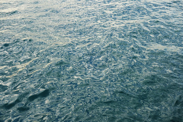 glossy surface with a complex reflection pattern as a background.