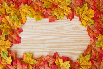Naklejka na ściany i meble maple leaf and free space for text with wooden background.
