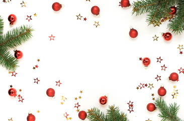 Fototapeta na wymiar Christmas background with fir twigs and Xmas or new year red color decorations on white background with empty copy space for text. top view