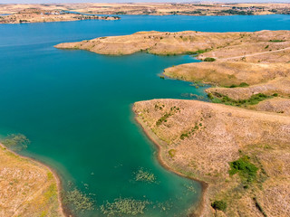 Aerial view of rural and agricultural areas south of Lokman in the province of Adiyaman, Turkey. Inlets on the Euphrates river formed by the Ataturk dam. Desert lands