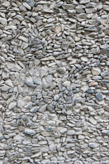Texture of a wall made of crushed stone plastered with cement