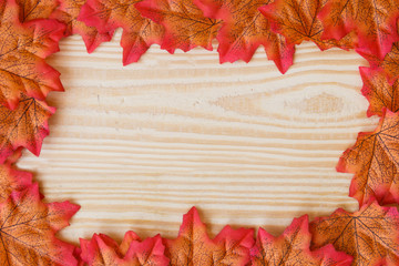 maple leaf and free space for text with wooden background.