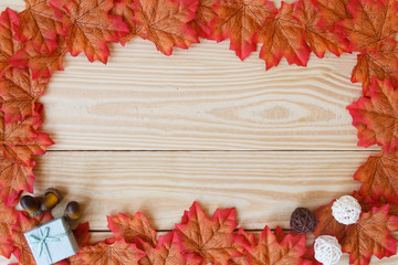 maple leaf and free space for text with wooden background.