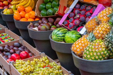 Assortment of fresh fruits at market, exotic fruits and berries.