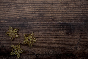 golden Christmas stars on rustic background