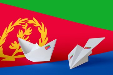 Eritrea flag depicted on paper origami airplane and boat. Handmade arts concept