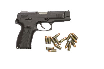 isolated black pistol with cartridges on a white background