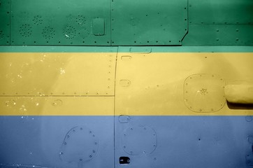 Gabon flag depicted on side part of military armored helicopter closeup. Army forces aircraft...