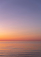 Fototapeta premium Vertical background of beuatiful sunset in the sea