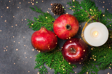 Festive botanical Christmas composition from natural materials fresh green cypress red apples...