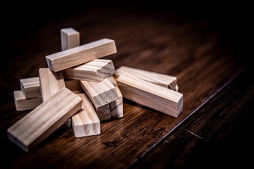 Wood puzzle pieces on wood flooring