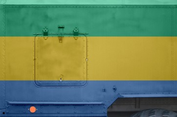 Gabon flag depicted on side part of military armored truck closeup. Army forces conceptual...