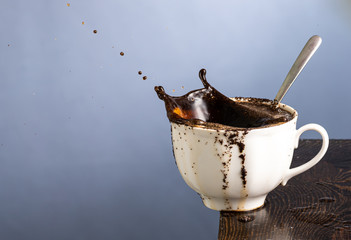 coffee mug with a falling slice of sugar and a splash from it falling