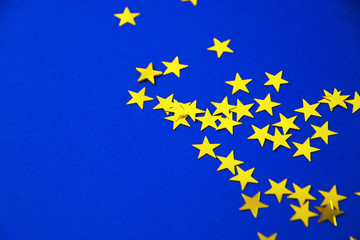 Bright holiday background, flatlay props stars on blue background copy space