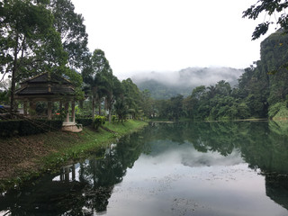 Fototapeta premium small water reservoir surrounded by green trees in Thailand south east asia