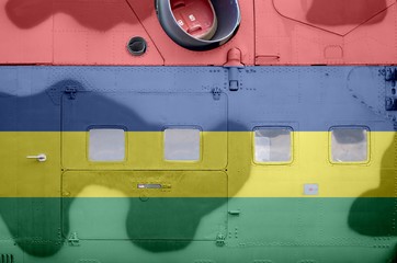 Mauritius flag depicted on side part of military armored helicopter closeup. Army forces aircraft...