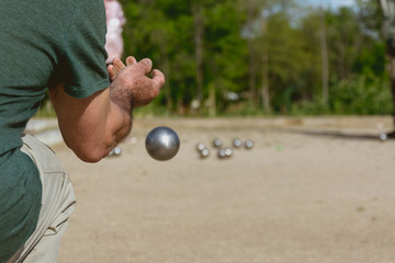 Senior people playing bocce in a park