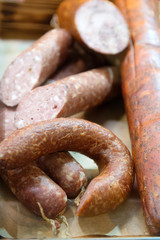 Smoked sausage of different types on the counter.