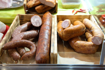 Smoked sausage of different types on the counter.