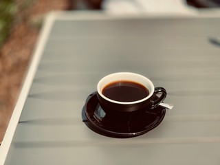 cup of coffee and notebook on wooden table