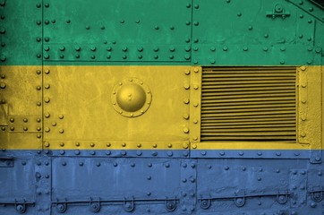 Gabon flag depicted on side part of military armored tank closeup. Army forces conceptual background