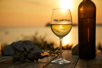two glasses with wine during sunset time