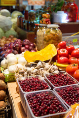 Vegetables and berries on the counter in the store.