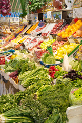 Market stall with fresh vegetables and herbs.