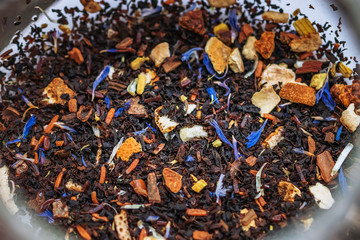 Close up of winter mix black tea tropical fruit cornflowers and spices in a teapot