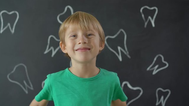 Little boy shows that some of his milk teeth had fallen out. Concept of tooth change in children