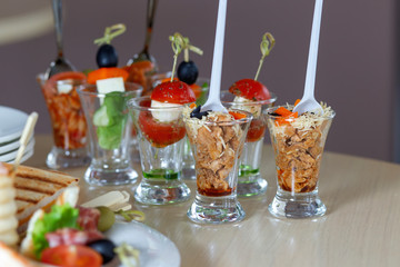 Meat salad in small glasses. Catering, quail eggs.
