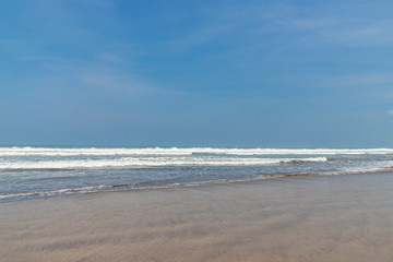 Ocean waves at sandy beach in Kuta, Denpasar, Indonesia
