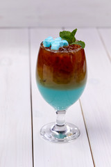blue cocktail with marshmallow and mint
