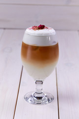 latte with rose on the wooden background