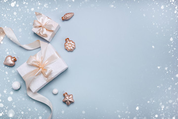 Christmas holiday composition, white gift boxes and golden Christmas toys on a light blue...