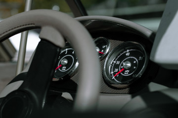 Dashboard of a fishing boat. Steering wheel, speedometer, tachometer and trim level