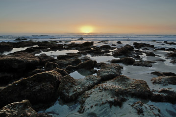 The rocky coast of Laguna Beach at sunset.