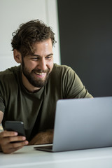 Web designer working on laptop in office 