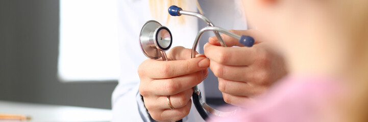 Female doctor arm hold stethoscope measuring patient heartbeat
