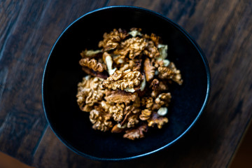 Walnut Kernels and Whole walnuts in Porcelain Bowl.