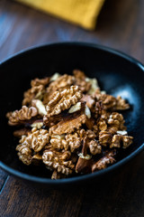 Walnut Kernels and Whole walnuts in Porcelain Bowl.