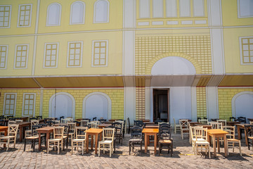 Chavern with chairs and tables on the promenade of the port of Chania