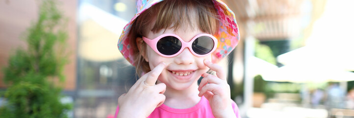 Happy smiling girl child in sunglasses outdoor portrait