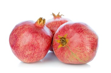 A group of whole pomegranate fruits on a white background