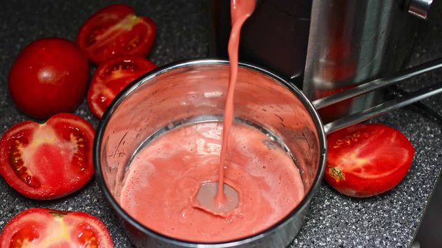 Tomato juice dripping from a juicer