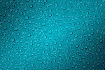 Wet with water drops turquoise background with gradient illumination at two corners, closeup, details