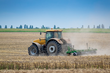 Tractor cultivating the field