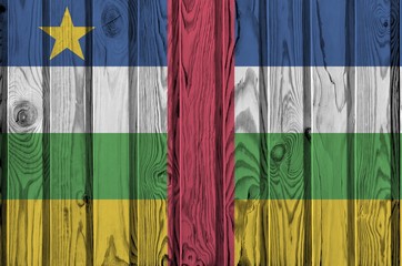 Central African Republic flag depicted in bright paint colors on old wooden wall. Textured banner...