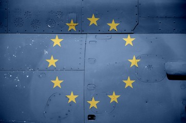 European union flag depicted on side part of military armored helicopter closeup. Army forces...