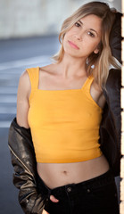 Woman in Yellow Top and Leather Jacket Outside